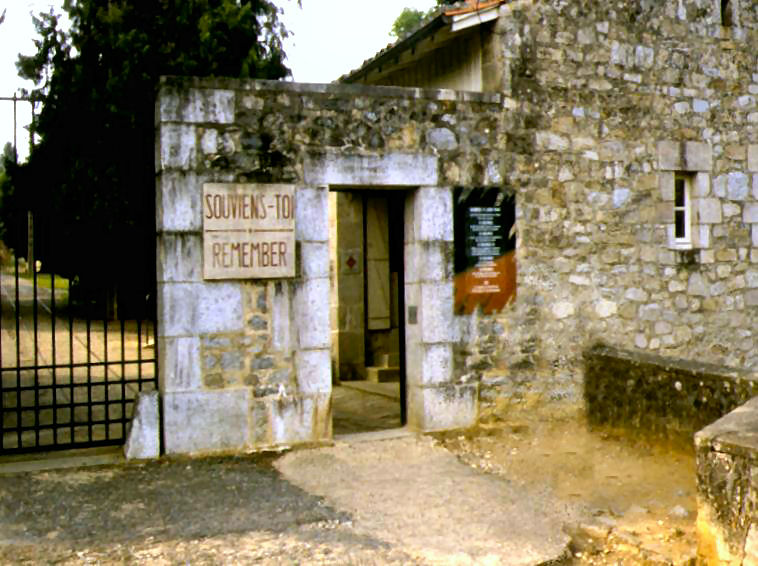 Old southern  entrance to Oradour showing the "Souviens Toi : Remember!" notice